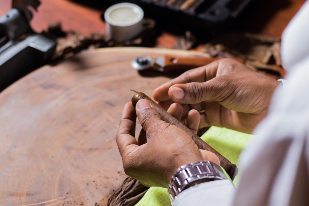 A close-up of a tobacco-making process in a ciagr lounge