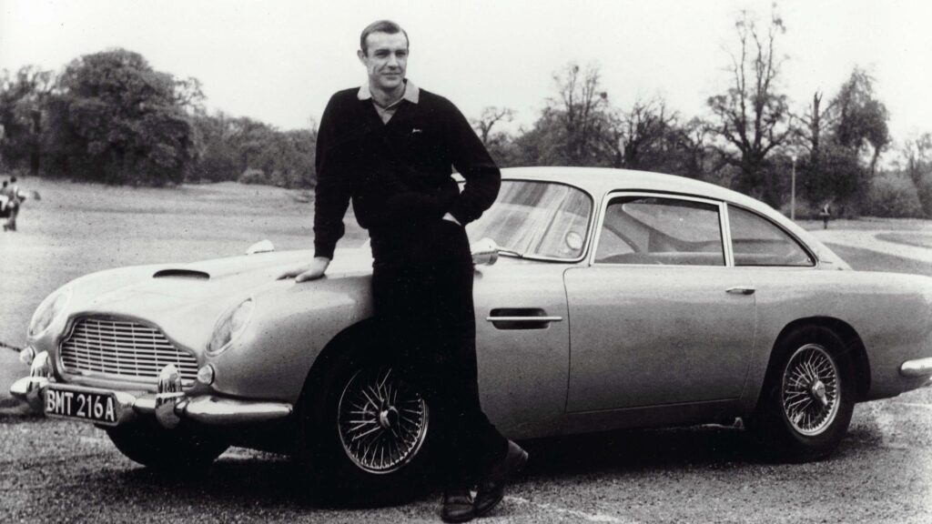 Sean Connery as James Bond with his Aston Martin DB5